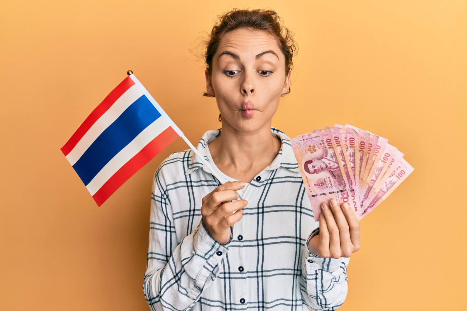 Thai Translator holding currency and flag